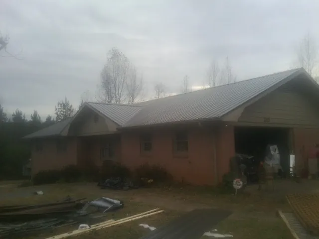 Gray metal roof on a stucco house with an attached garage in Elkton